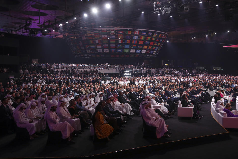 FILE - People attend the 2022 soccer World Cup draw at the Doha Exhibition and Convention Center in Doha, Qatar, Friday, April 1, 2022. Many think Qatar is hosting the event to project its influence, build international connections and move past a human-rights record criticized by international groups and workers’ advocates. Critics describe the 2022 World Cup, which starts Sunday, as a classic case of “sportswashing” — using sports to change a country or company's image. (AP Photo/Hussein Sayed, File)