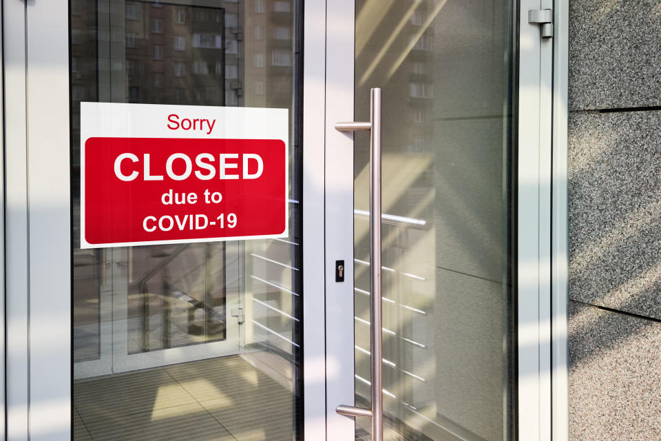 Business center closed due to COVID-19, sign with sorry in door window. Stores, restaurants, offices, other public places temporarily closed during coronavirus pandemic. Economy hit by corona virus.