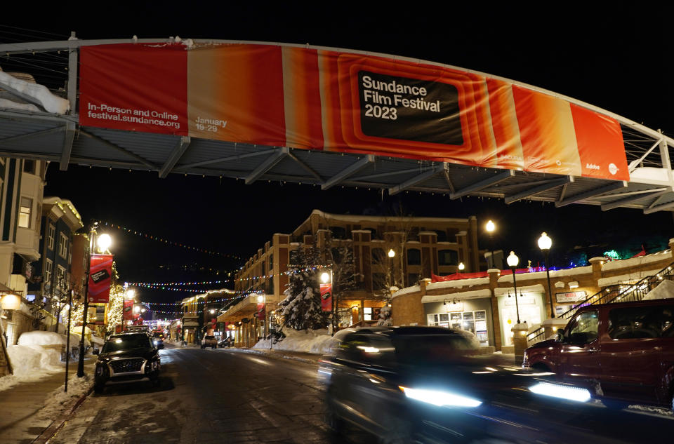 A car passes under a pedestrian bridge on Main Street on the day before the start of the 2023 Sundance Film Festival, Wednesday, Jan. 18, 2023, in Park City, Utah. The annual independent film festival runs from Jan. 19-29. (AP Photo/Chris Pizzello)