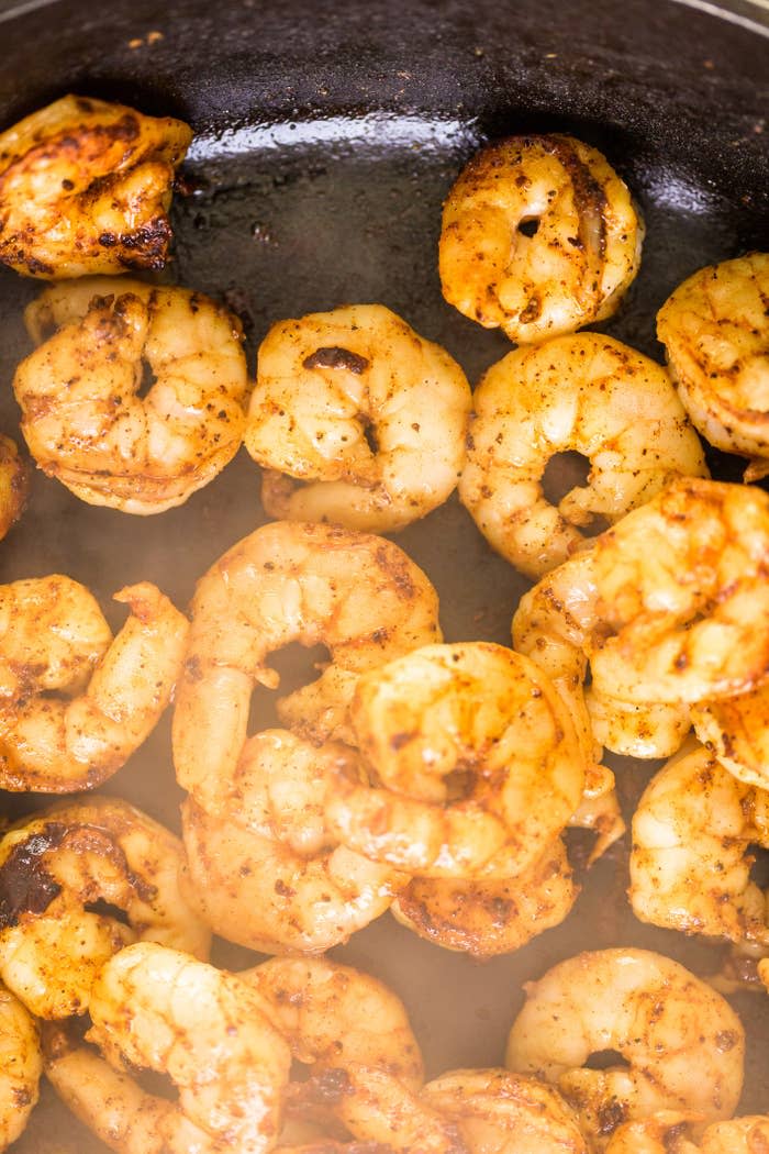 Shrimp cooking in a skillet.