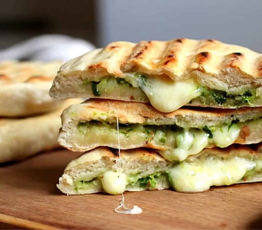 <p>Vintage Kitchen Notes</p><p>This grilled naan bread, filled with melting mozzarella and pesto, requires no yeast and can be grilled in a skillet or outdoors!</p><p><strong>Get the Recipe: </strong><a href="https://vintagekitchennotes.com/mozzarella-and-pesto-grilled-naan-bread/" rel="nofollow noopener" target="_blank" data-ylk="slk:Cheesy Pesto Naan Bread;elm:context_link;itc:0;sec:content-canvas" class="link ">Cheesy Pesto Naan Bread</a></p>