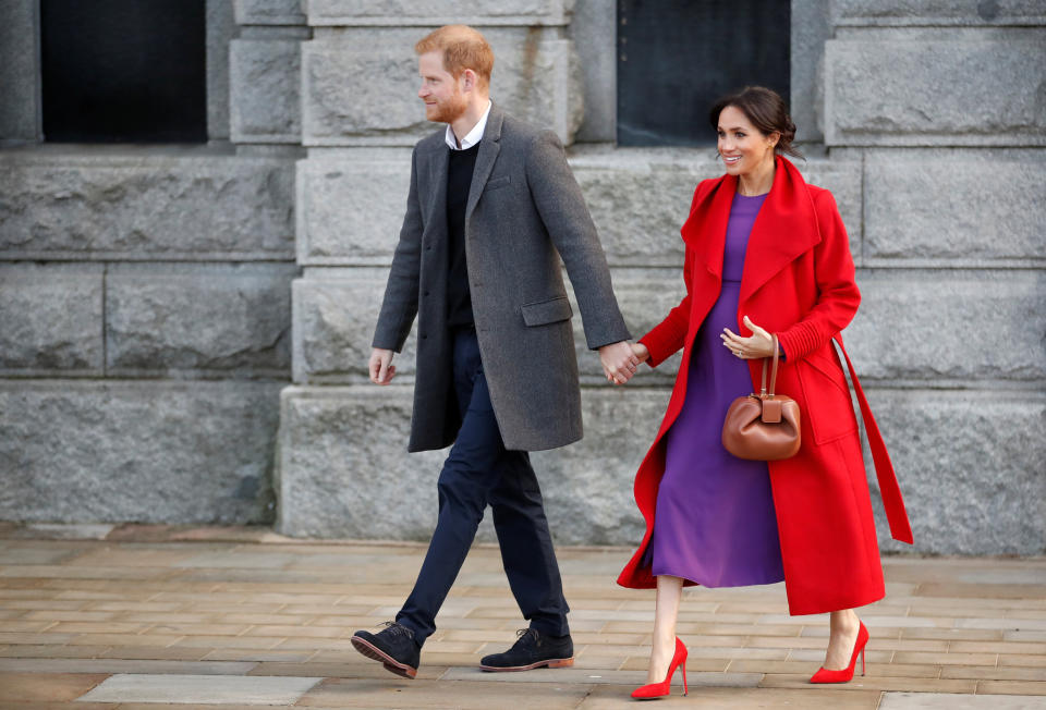 Prince Harry and Meghan, Duchess of Sussex, walk during their visit in Birkenhead, Britain.