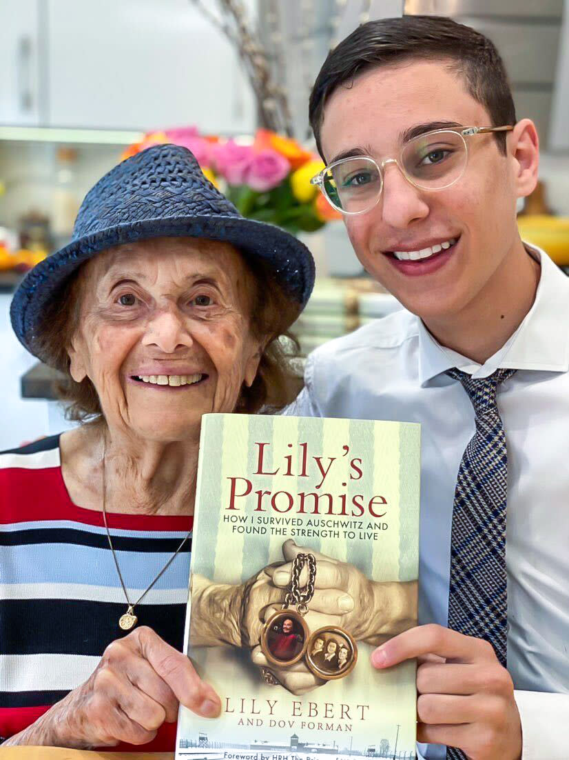 Dov Forman and his great-grandmother Lily Ebert holding their book 