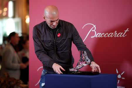 Former French soccer player and European Leukodystrophy Association (ELA) patron Zinedine Zidane poses with the "Zidane's Crystal Foot" created by Baccarat in Paris, France, June 12, 2018. REUTERS/Benoit Tessier