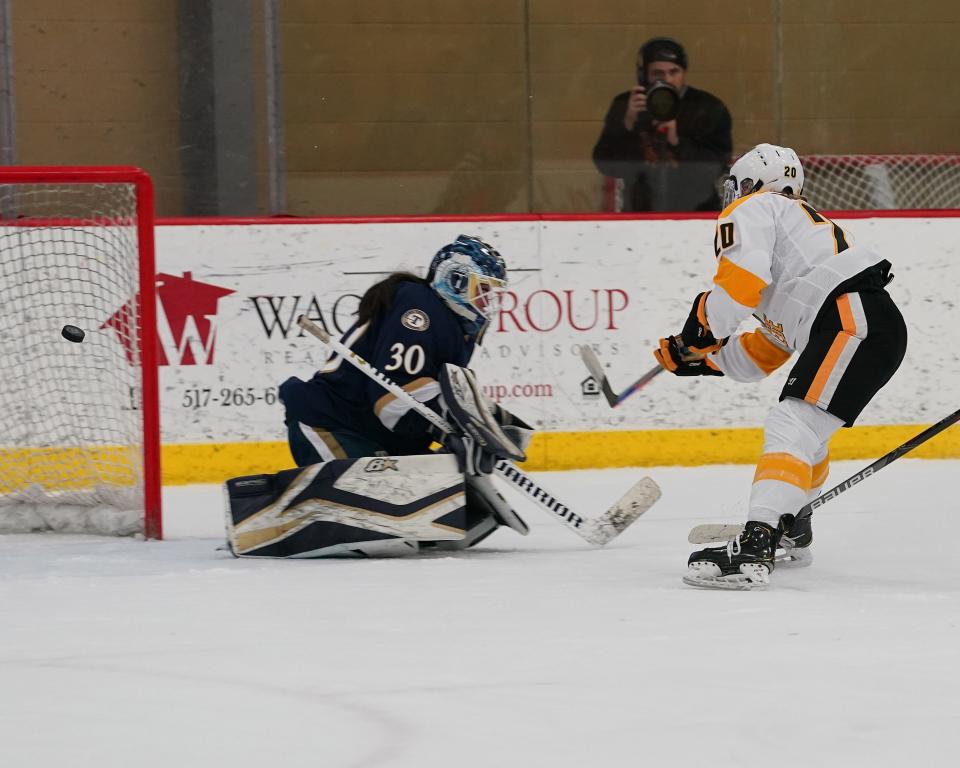 Adrian College's Jessica VonRuden beats Trine's goalie for a goal during Saturday's game at Arrington Ice Arena.