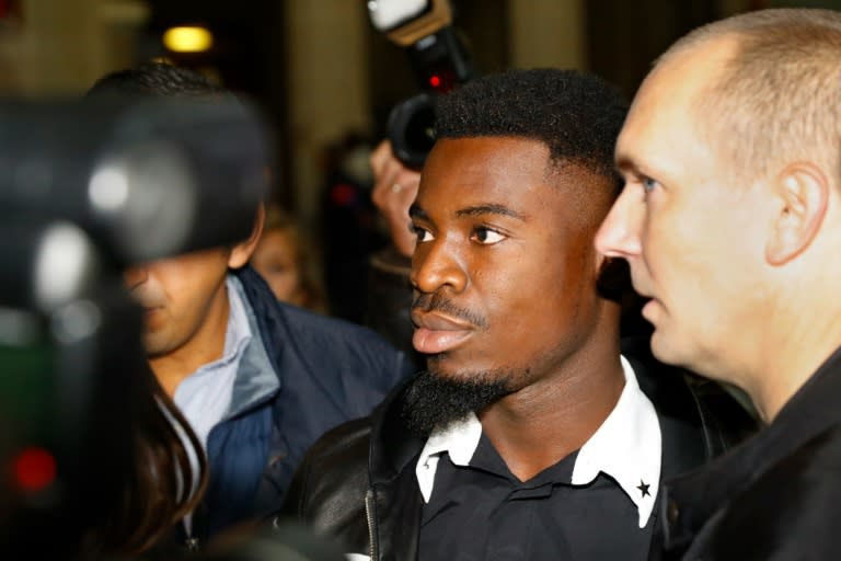 Paris Saint-Germain's defender Serge Aurier (C) rejects the police account of the incident and says he was the victim of violence