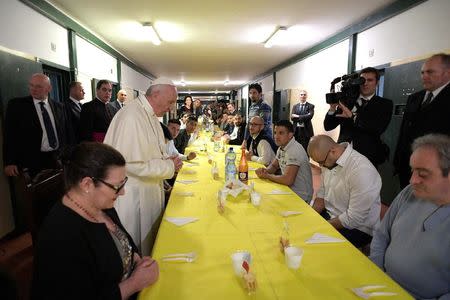 Pope Francis leads prayers before lunch with inmates in the Third Wing of the San Vittore Prison in Milan, Italy, March 25, 2017. Osservatore Romano/Handout via Reuters