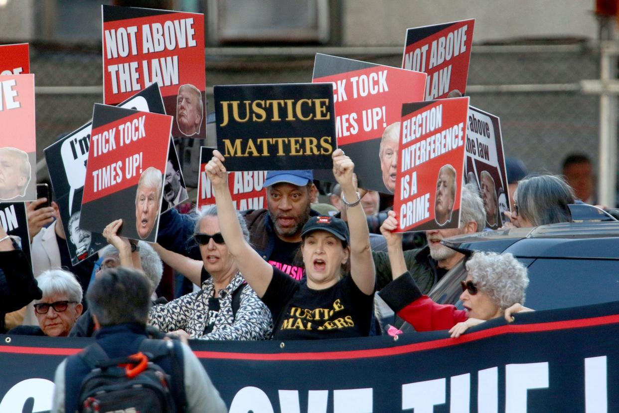 Protestors march along Centre Street in New York City before Former President Donald Trump arrived at NY Criminal Court Monday morning, April 15, 2024.