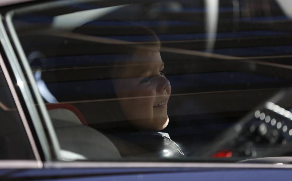 Leukemia survivor Miles dressed as "Batkid" smiles as he sits in the Batmobile after apprehending the "Riddler" as part of a day arranged by the Make-A-Wish Foundation in San Francisco