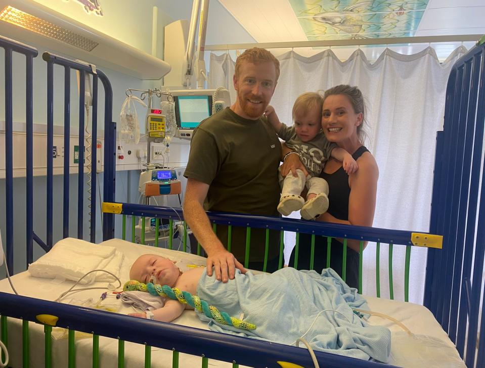 The family visit baby Jesse in hospital after his stoma reversal. (Karen Patterson /SWNS)