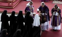 French Bishop Jean-Michel Faure (2nd R) gives holy communions during a mass in Nova Friburgo near Rio de Janeiro March 28, 2015. REUTERS/Stephen Eisenhammer