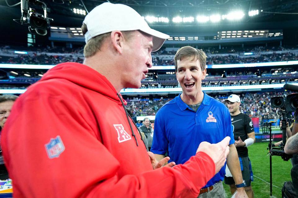LAS VEGAS, NEVADA - FEBRUARY 05: AFC head coach Peyton Manning and NFC head coach Eli Manning meet on the field after the 2023 NFL Pro Bowl Games at Allegiant Stadium on February 05, 2023 in Las Vegas, Nevada. (Photo by Jeff Bottari/Getty Images)
