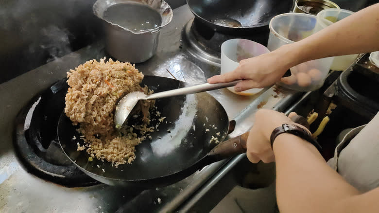 tossing stir fry in wok