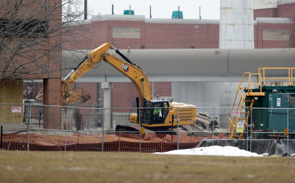 Crews work to remediate soil containing residue from a former manufactured gas plant around the former WPS headquarters building on Jan. 10, 2023, in Green Bay, Wis.