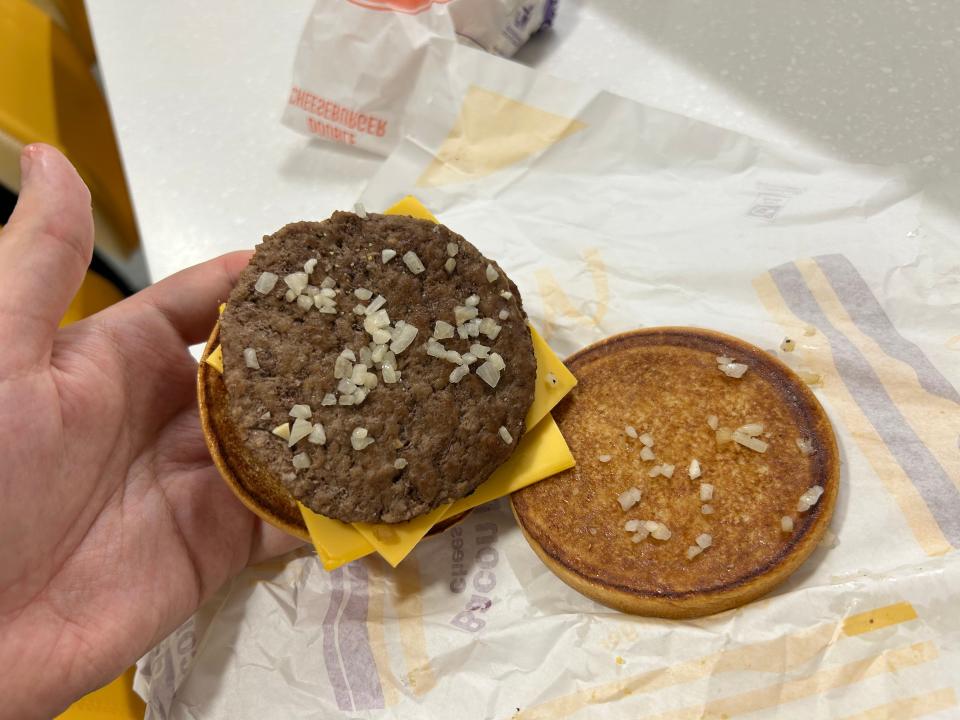 An open McDonald's Double Cheeseburger showing the grilled onions.