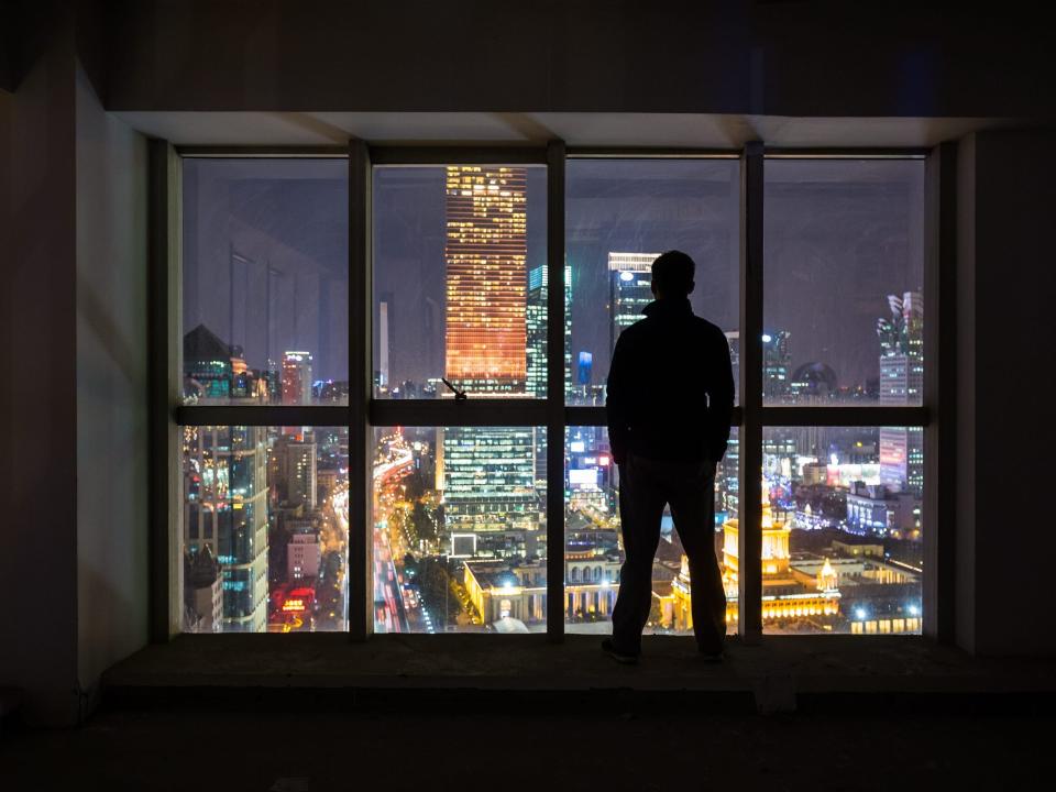 Silhouette of a man overlooking the city of Shanghai.