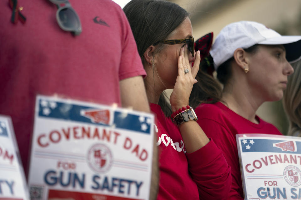 FILE - Covenant School parent Lori Buck wipes away tears during a demonstration for gun control legislation, April 18, 2023, in Nashville, Tenn. Participants created a human chain spreading from Monroe Carell Jr. Children's Hospital at Vanderbilt, where victims of The Covenant School shooting were taken on March 27, to the Tennessee Capitol. Documents obtained by The Associated Press show Tennessee Gov. Bill Lee’s administration accused the National Rifle Association of wanting to use involuntary commitment laws "to round up mentally ill people and deprive them of other liberties." (AP Photo/George Walker IV, File)