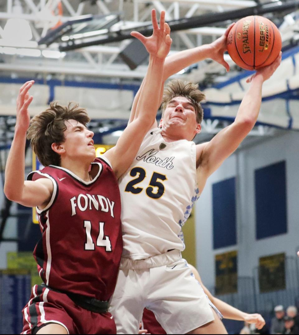 Fond du Lac’s Eli Braatz (14) tries to block Tyler Schoessow (25) at the basket at Sheboygan North, Tuesday, November 29, 2022, in Sheboygan, Wis.