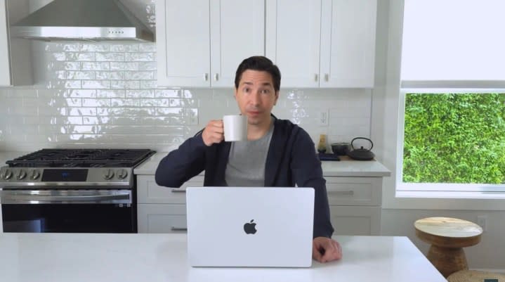 Justin Long sits with a MacBook and drinks tea.