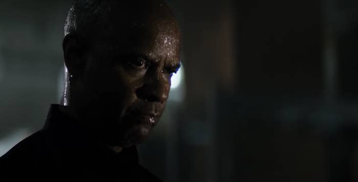 Denzel glaring, his face wet