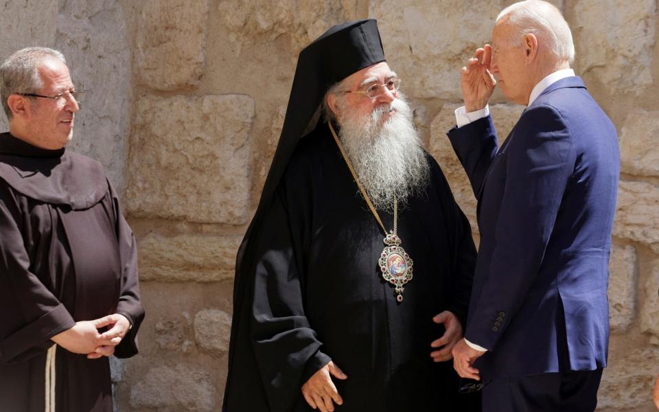 Joe Biden crosses himself as he visits the Church of Nativity in Bethlehem in the Israeli-occupied West Bank - Reuters
