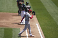 Los Angeles Angels' Shohei Ohtani (17) walks toward the dugout after being relieved during the first inning of a baseball game against the Oakland Athletics in Oakland, Calif., Sunday, July 26, 2020. Athletics' Robbie Grossman, top left, hit an RBI-single. (AP Photo/Jeff Chiu)