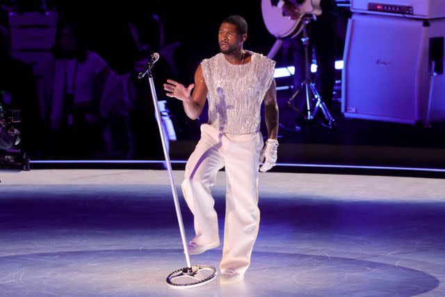 <p>Ethan Miller/Getty</p> Usher performs at the Super Bowl LVIII halftime show