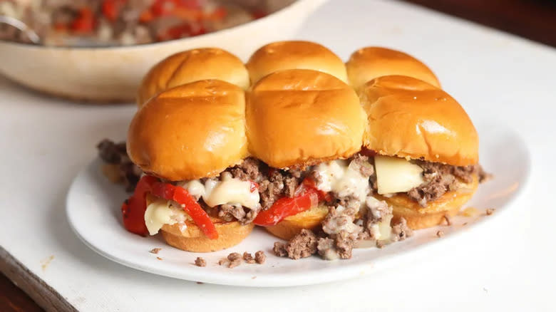 A group of Philly cheesesteak sliders on a plate
