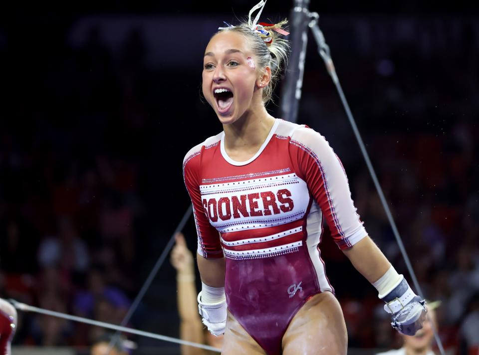 Oklahoma's Audrey Davis celebrates in the bars during the University of Oklahoma Sooners women's gymnastics meet with BYU, Texas Woman's University and Utah State at the Lloyd Noble Center in in Norman, Okla., Friday, Feb. 9, 2024.