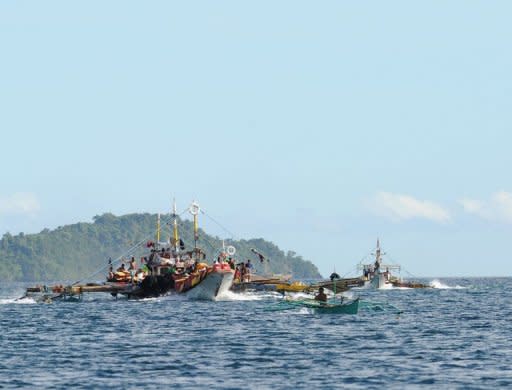 Philippine fishermen aboard their motorised boats sail along Ulugan Bay, in Puerto Princesa, Palawan island in April 2012. The Philippines will bid out oil exploration contracts in the South China Sea despite recent tensions with China over conflicting territorial claims in those waters, an official said Wednesday