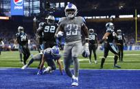 Detroit Lions running back Kerryon Johnson (33) rushes for an 8-yard touchdown during the first half of an NFL football game against the Carolina Panthers, Sunday, Nov. 18, 2018, in Detroit. (AP Photo/Duane Burleson)