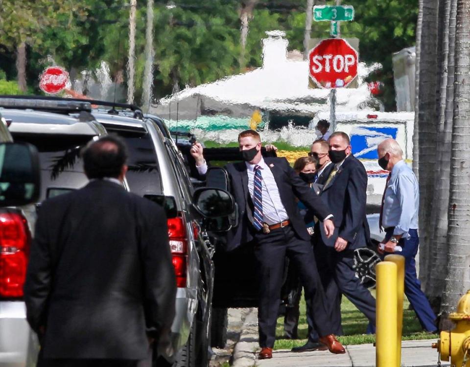 Joe Biden, right, is ushered by his Secret Service detail as he leaves the Little Haiti Cultural Complex during a brief visit to Little Haiti on Monday, October 5, 2020.