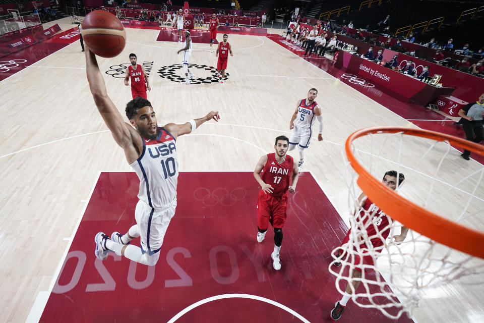 United States' Jayson Tatum (10) drives to the basket ahead of Iran's Navid Rezaeifar (17) during a men's basketball preliminary round game at the 2020 Summer Olympics, Wednesday, July 28, 2021, in Saitama, Japan. (Charlie Neibergall/Pool Photo via AP)