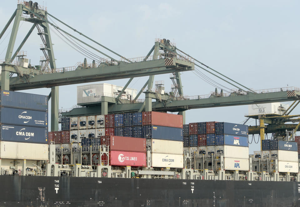 FILE - In this May 3, 2020, file photo, containers are loaded on a ship at the Saigon port in Ho Chi Minh City, Vietnam. The World Bank on Tuesday, Sept. 28, 2021, cut its economic growth forecast for developing countries in East Asia due to the impact of the coronavirus’s delta variant and called on governments to help the poor and small businesses avoid long-term damage. (AP Photo/Hau Dinh, File)