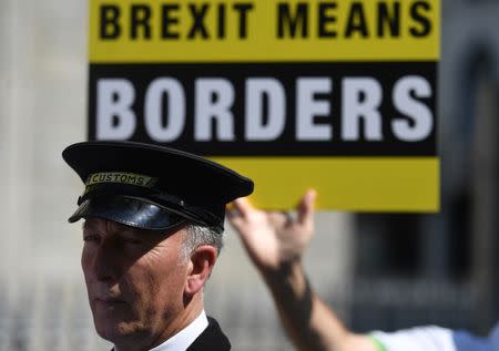 An actor dressed as a Customs officer joins a 'Borders Against Brexit' protest in the border town of Dundalk, Ireland, June 28, 2018. REUTERS/Clodagh Kilcoyne