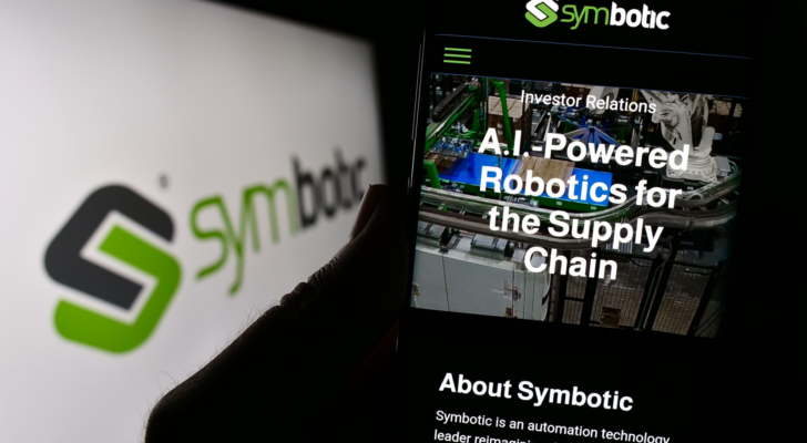 Person holding smartphone with website of US robotics warehouse company Symbotic Inc. on screen with logo. Focus on center of phone display. Unmodified photo. SYM stock
