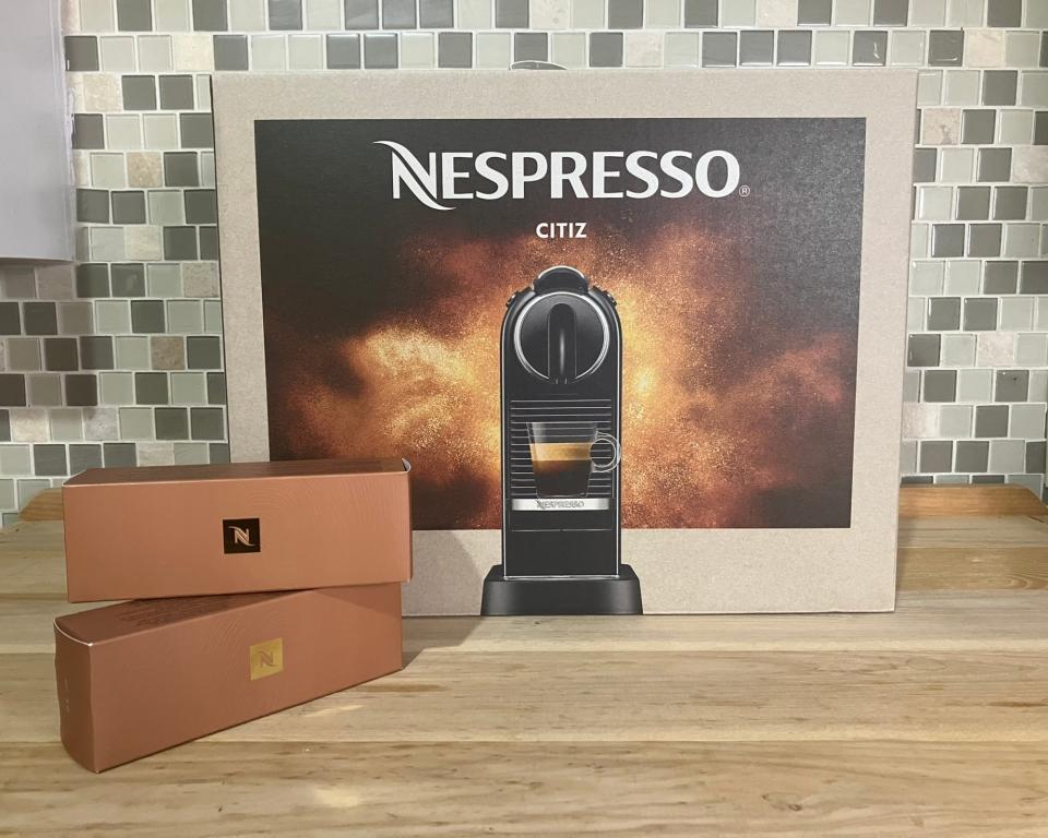 Nespresso Citiz outer packaging with two boxes of Nespresso pods on kitchen countertop