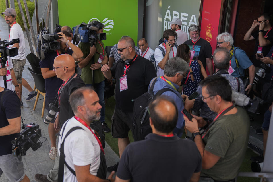 Photographers and TV camera operators leave a press room of the Spanish Football Federation building after no access was granted in Las Rozas on the outskirts of Spain, Friday, Aug. 25, 2023. Spanish Federation president Luis Rubiales has refused to resign despite an uproar for kissing a player, Jennifer Hermoso on the lips without her consent after the Women's World Cup final. Rubiales had also grabbed his crotch in a lewd victory gesture from the section of dignitaries with Spain's Queen Letizia and the 16-year old Princess Sofía nearby. (AP Photo/Paul White)