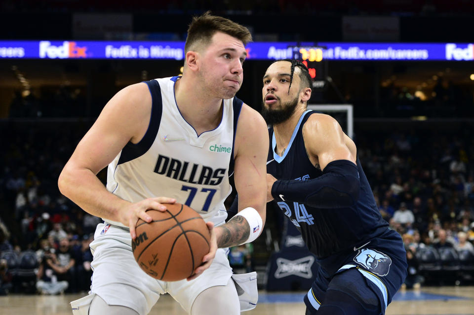 Dallas Mavericks guard Luka Doncic (77) is defended by Memphis Grizzlies forward Dillon Brooks (24) during the second half of an NBA basketball game Wednesday, Dec. 8, 2021, in Memphis, Tenn. (AP Photo/Brandon Dill)