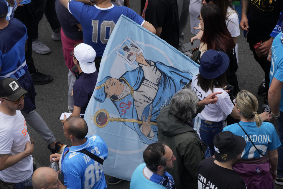 Fans walk outside the stadium before the Serie A soccer match between Napoli and Salernitana at the Diego Armando Maradona stadium, in Naples, Italy, Sunday, April 30, 2023. (AP Photo/Gregorio Borgia)