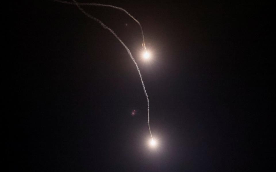 Traces of the explosions are seen in the sky over the city during a Russian missile strike - GLEB GARANICH/REUTERS