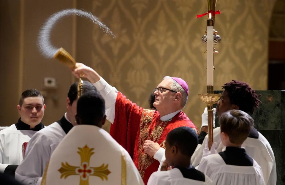 Bishop Thomas Tobin blesses the congregation during Palm Sunday services at the Cathedral of Saints Peter and Paul in 2023.