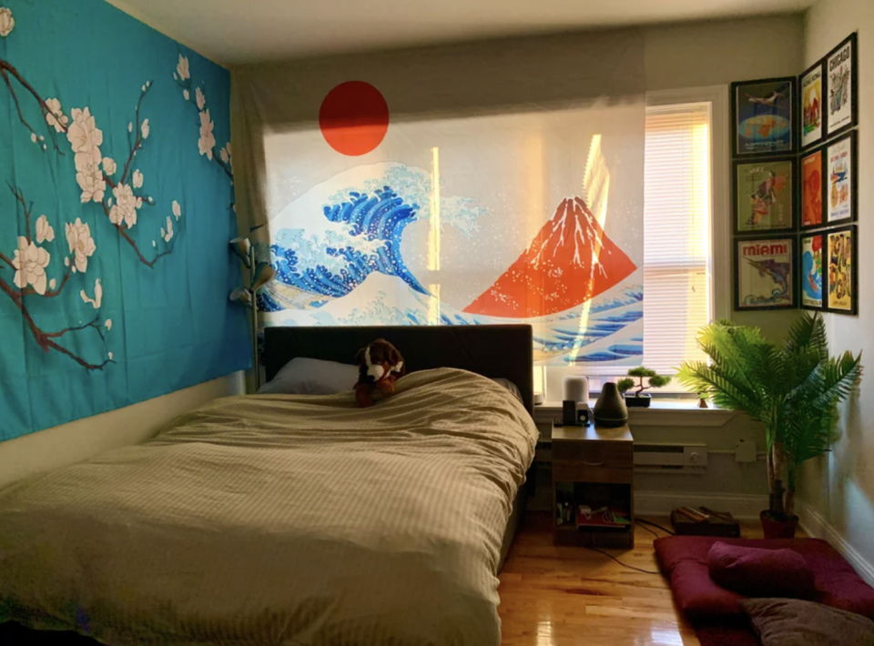 This Japanese culture-inspired room has a print of a cherry blossom branch in addition to a print of the popular "Under The Wave of Kanagawa"