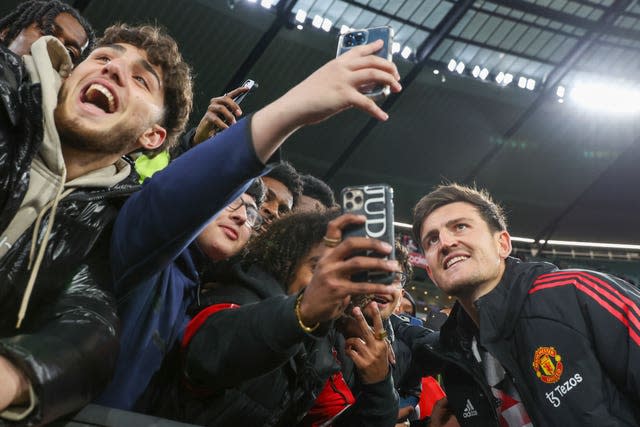 Manchester United’s Harry Maguire poses for a selfie with fans in Melbourne