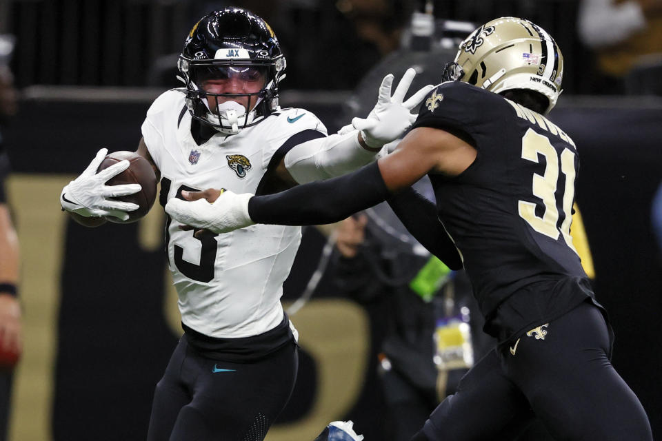 Jacksonville Jaguars wide receiver Christian Kirk, left, runs past New Orleans Saints safety Jordan Howden (31) for a 44-yard touchdown on a pass play in the second half of an NFL football game in New Orleans, Thursday, Oct. 19, 2023. (AP Photo/Butch Dill)