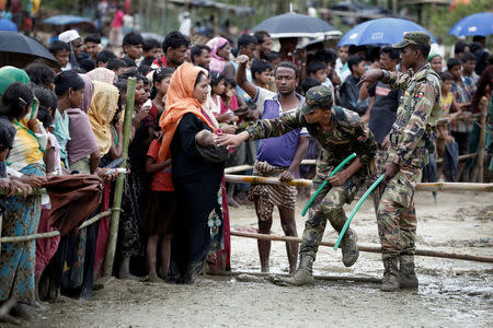 Rohingya refugees queue for aid in Cox's Bazar, Bangladesh, September 28, 2017. REUTERS/Cathal McNaughton