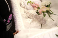 Nahasia Robinson, who died at age 27, is seen with flowers in her hands during a viewing at The Family Funeral Home, Thursday April 30, 2020, in Newark, N.J. A wave of shaken families has had to honor the dead apart and in small groups during an era of social distancing. (AP Photo/Seth Wenig)