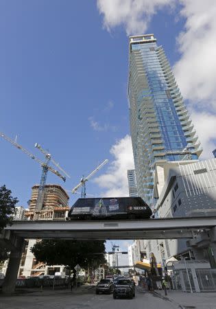 A Peoplemover car is shown with new condominium construction in the background in downtown Miami, Florida November 5, 2015. REUTERS/Joe Skipper