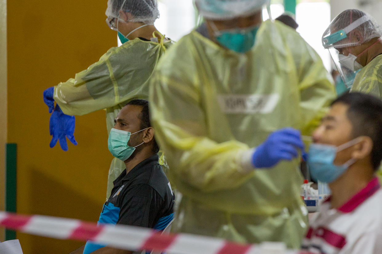 A man receives a nasal swab at The Float @ Marina Bay on 12 June 2020. The site is now a regional  COVID-19 screening centre. (PHOTO: Dhany Osman / Yahoo News Singapore)