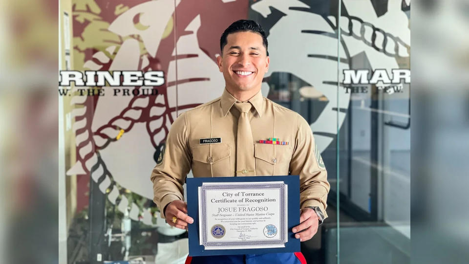 U.S. Marine Corps Staff Sergeant Josue Fragoso, the station commander of Recruiting Sub Station South Bay, Recruiting Station Orange County, 12th Marine Corps District, poses for a photo with a certificate of recognition from Torrance Mayor, George Chen, in Torrance, California on Dec. 22, 2022. (U.S. Marine Corps photo by Staff Sgt. Immanuel Johnson).